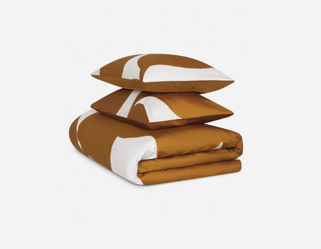 A stack of pillows with a brown and white pattern.